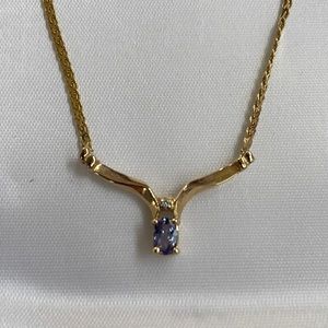 14k Gold, blue topaz and diamond pendant necklace.